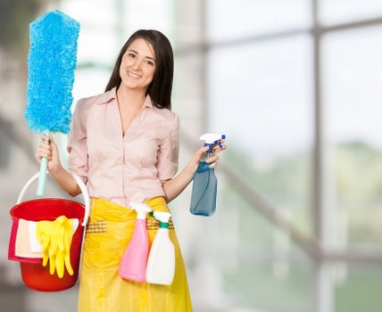 Carpet cleaning technician using safe equipment in a home setting